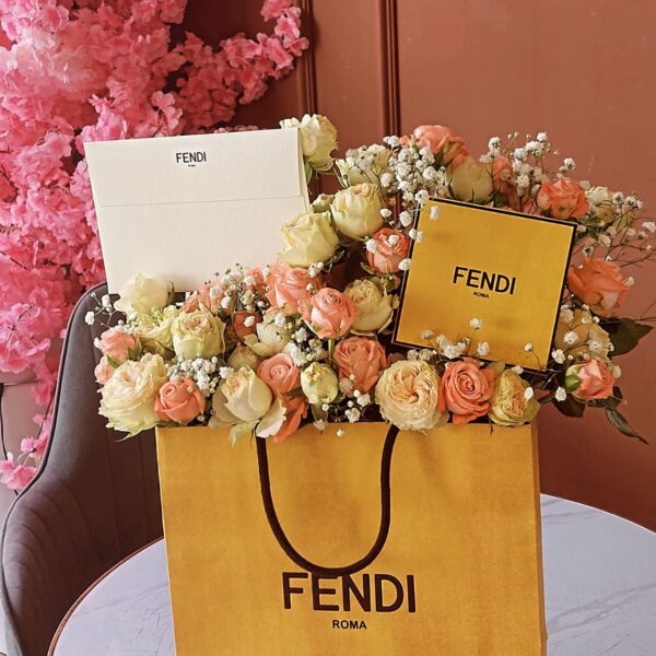 Paper Bag With Gift And Flower Arrangement